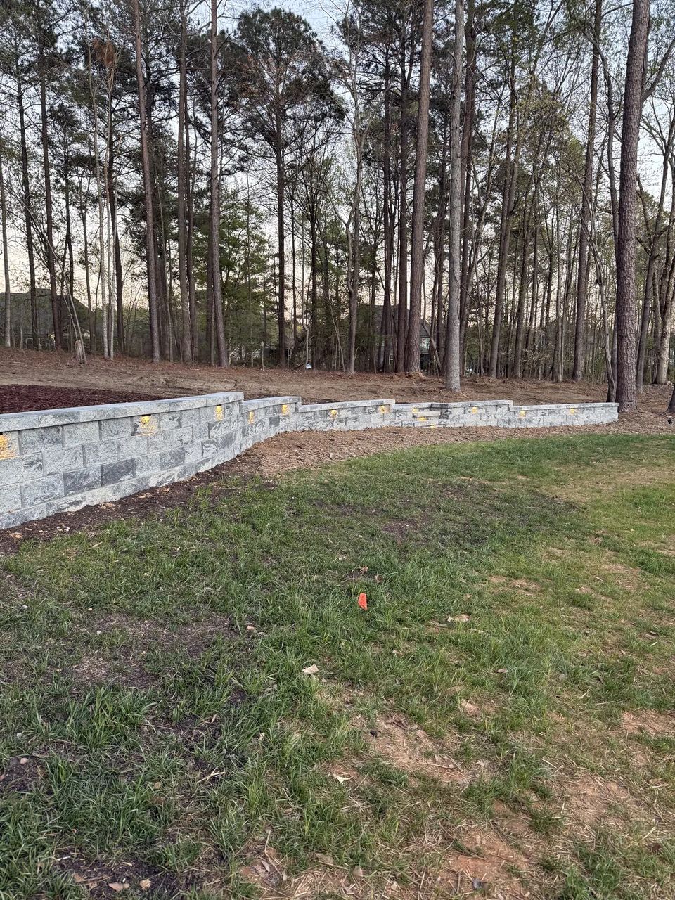Curved wall seen across the new lawn