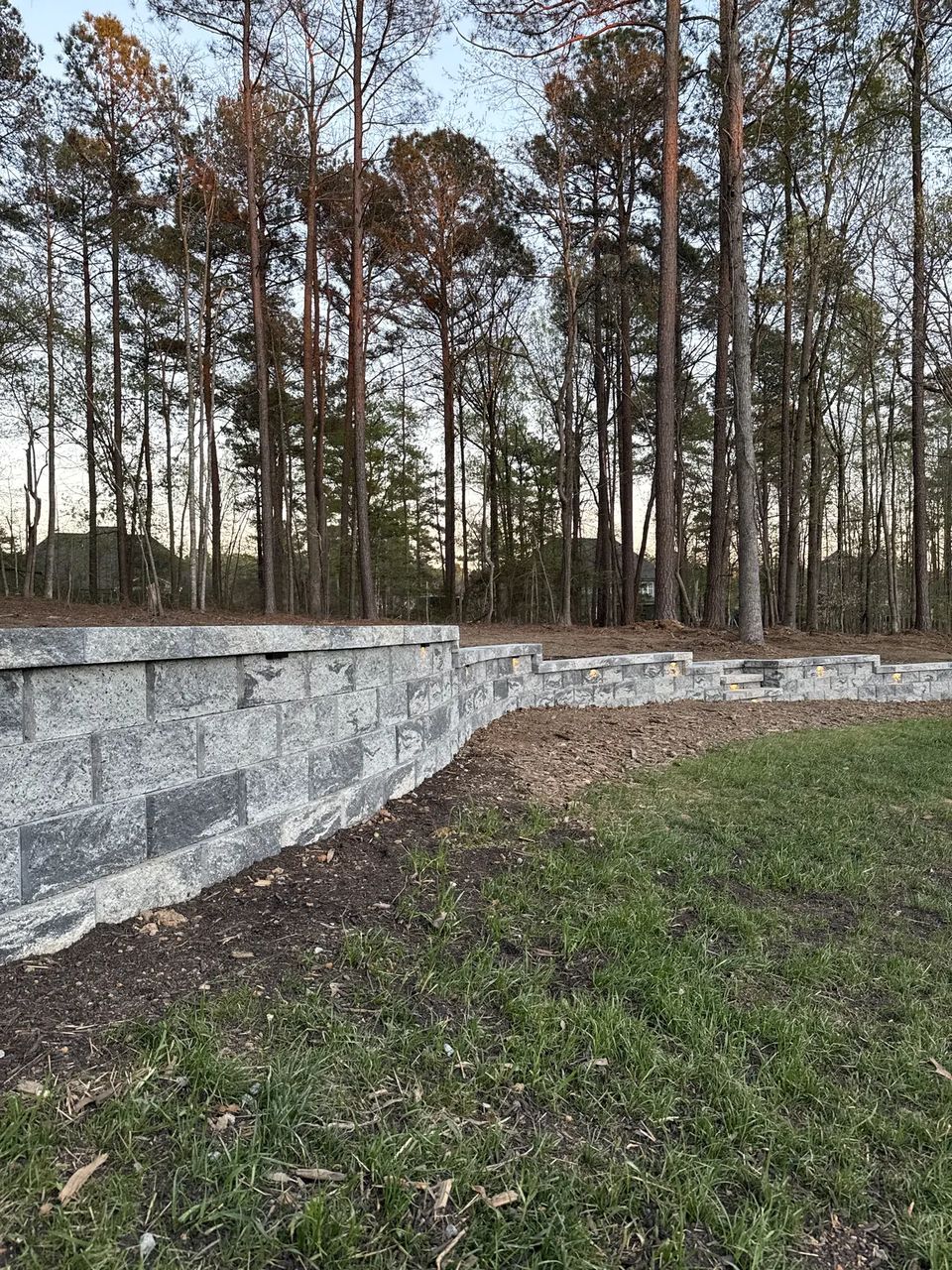 Curved retaining wall with lights along its face