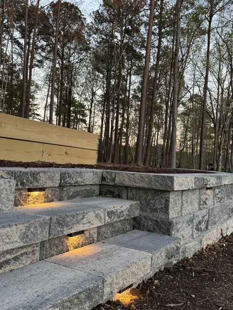 Lit steps built into the curved retaining wall