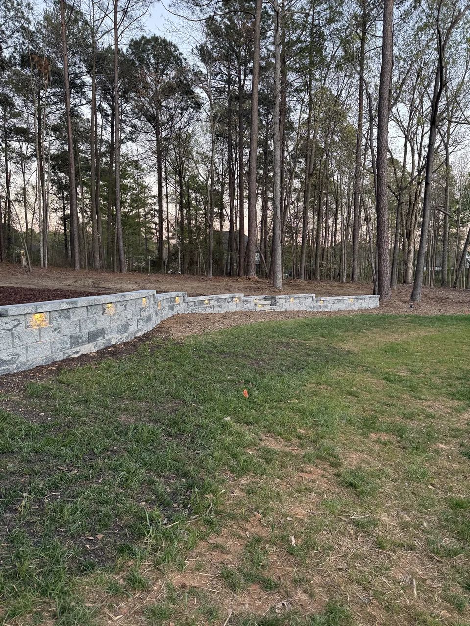 New lawn below the finished curved retaining wall