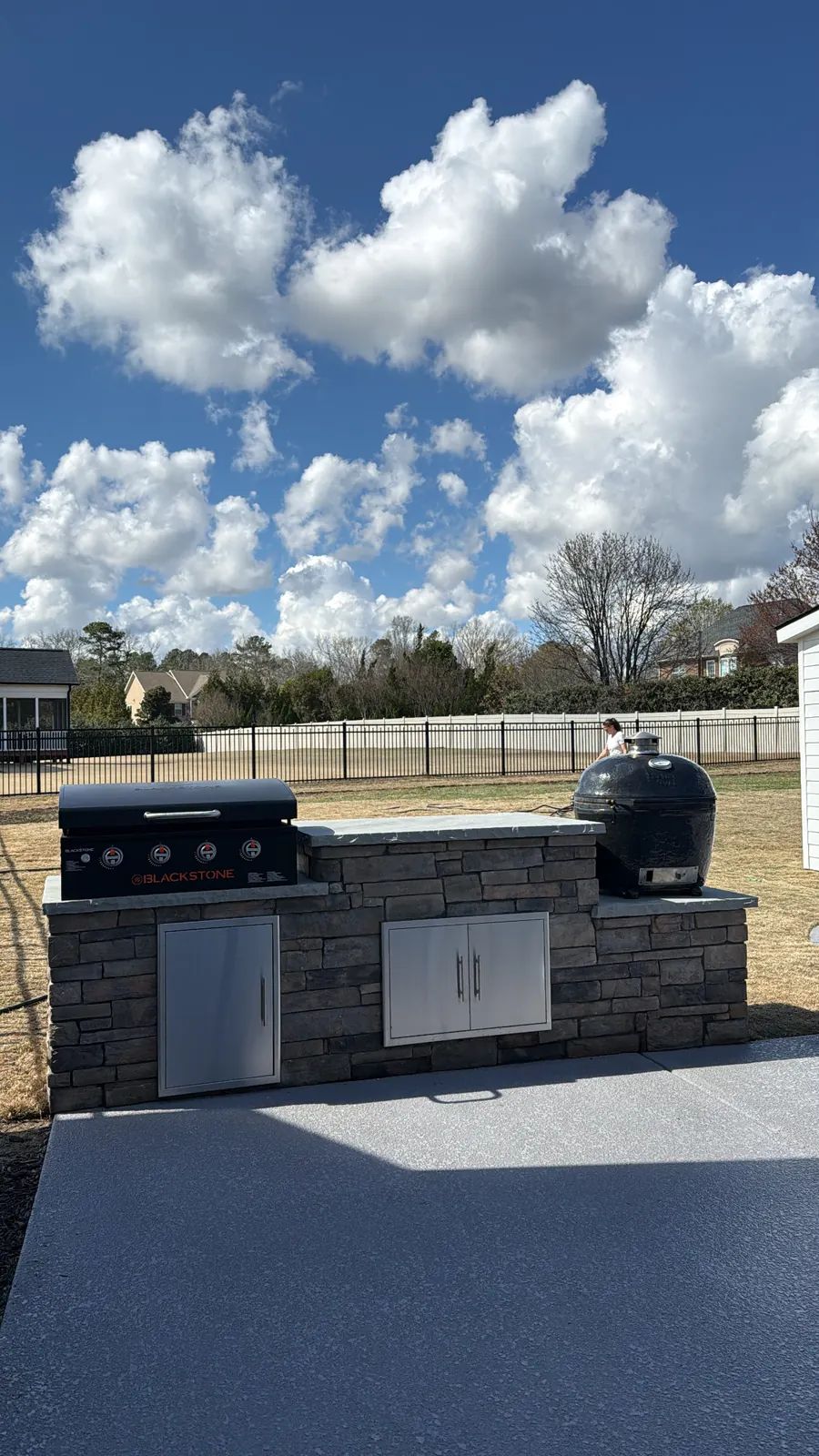 Grill island with a flat top griddle and a kamado grill