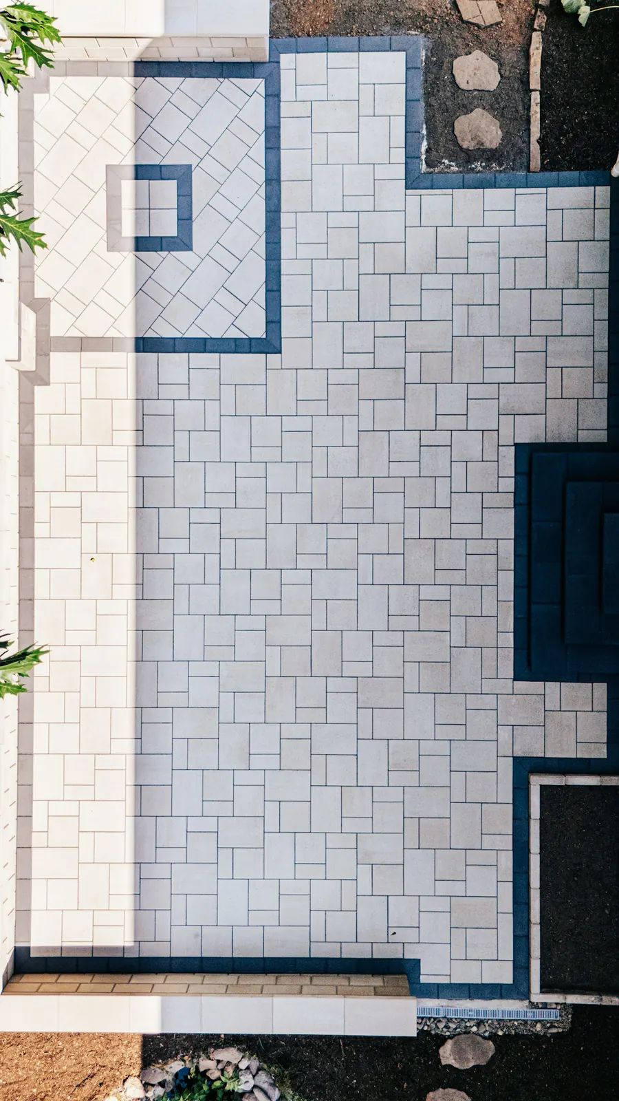 Drone view of a patio with a square medallion and dark border