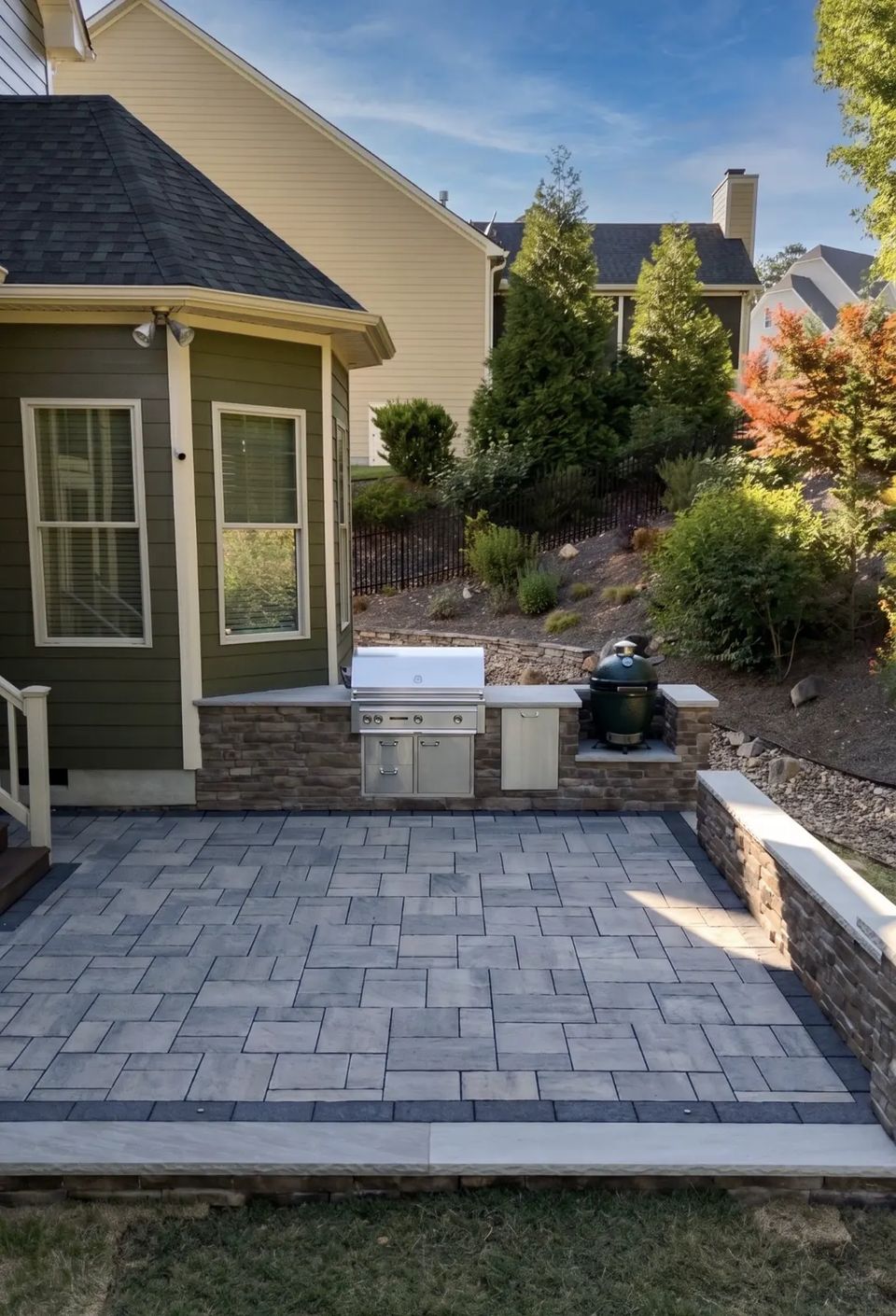 Kitchen patio and grill island beside the house