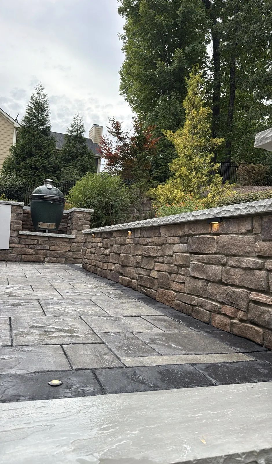 Stone seat wall running along the kitchen patio