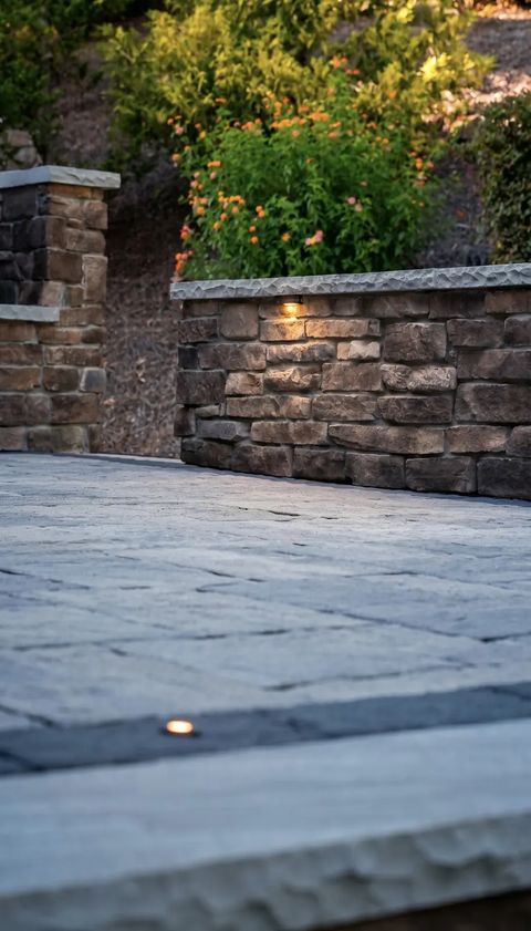 Seat wall caps glowing at dusk below the planted bed