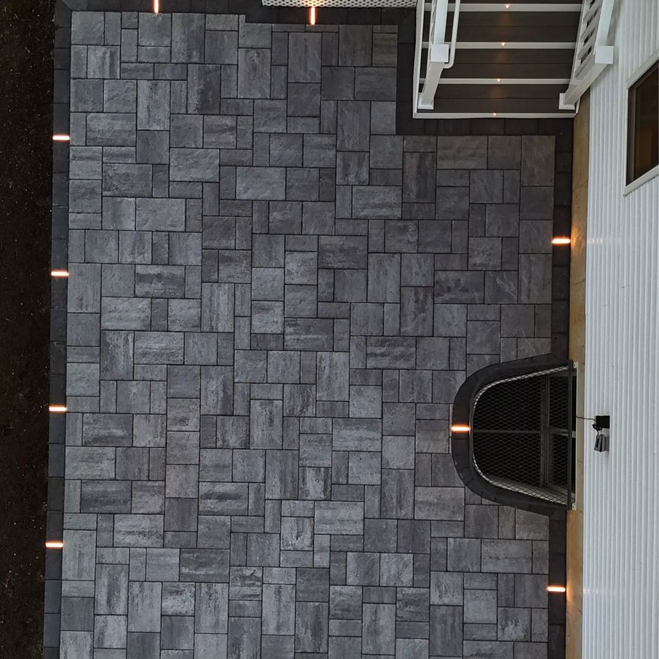 Overhead view of a paver patio with border lights