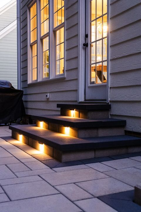 Wide lit steps below a set of French doors at dusk
