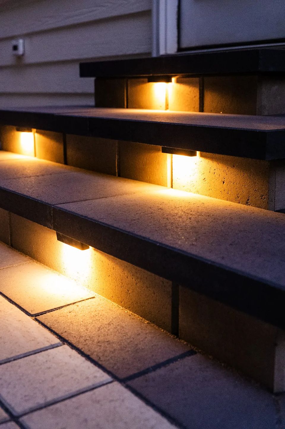 Close view of step lights set under paver treads