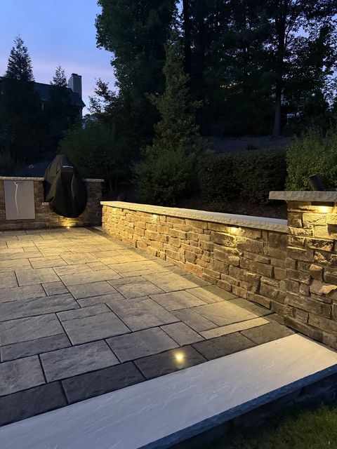 Seat wall cap lights running along the patio at dusk
