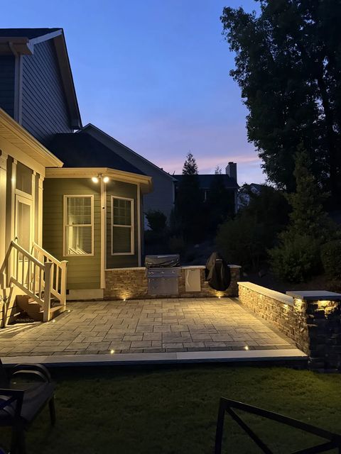Porch steps and patio glowing at dusk