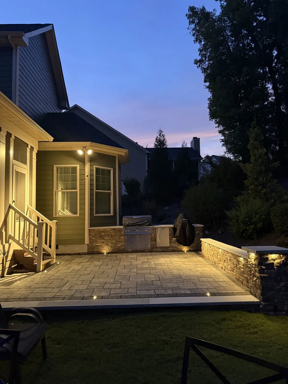 Porch steps and patio glowing at dusk