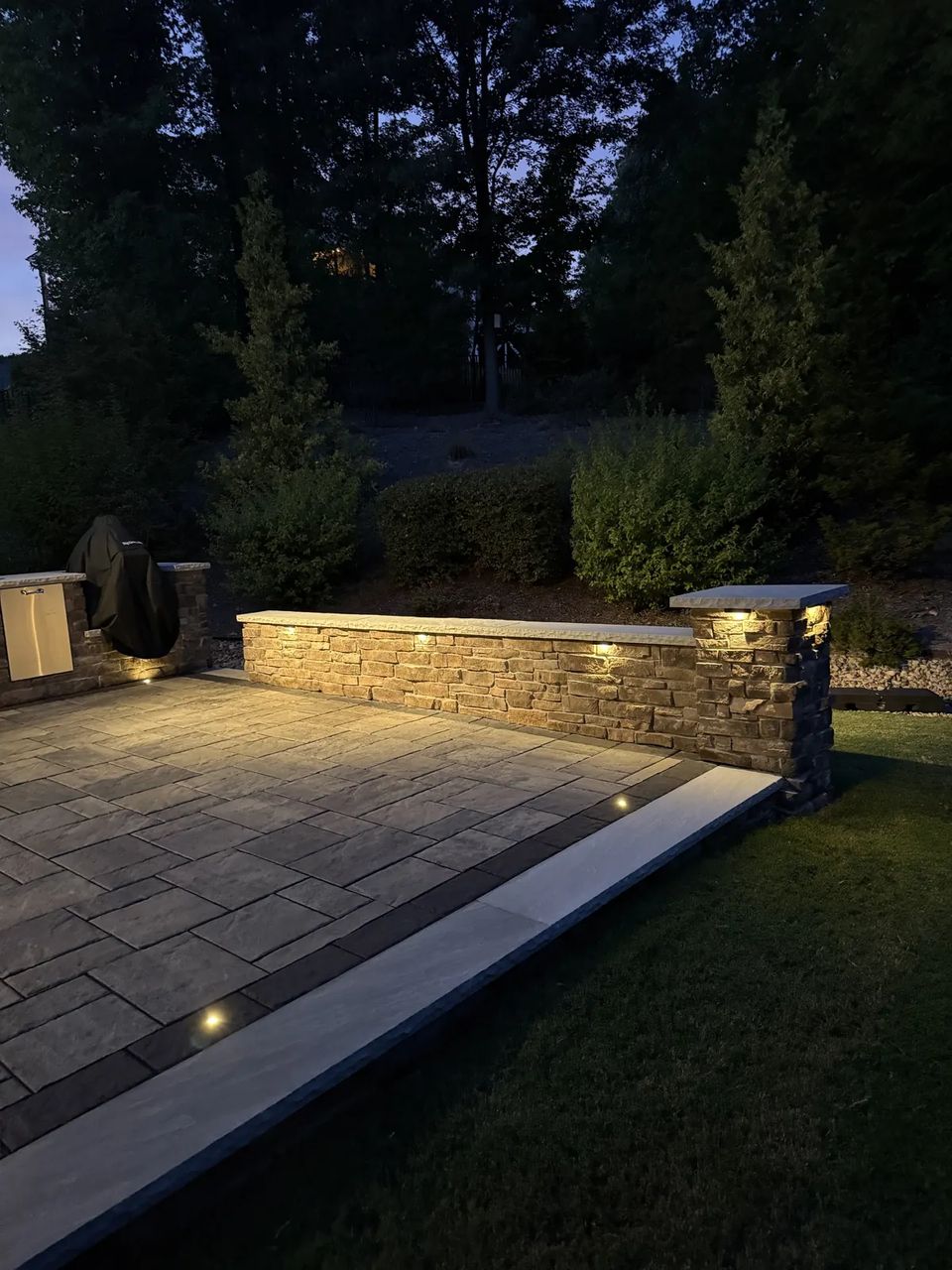 Wall lights along the patio edge after dark