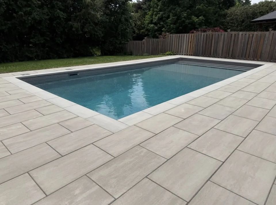 Large format paver pool deck around a rectangular pool