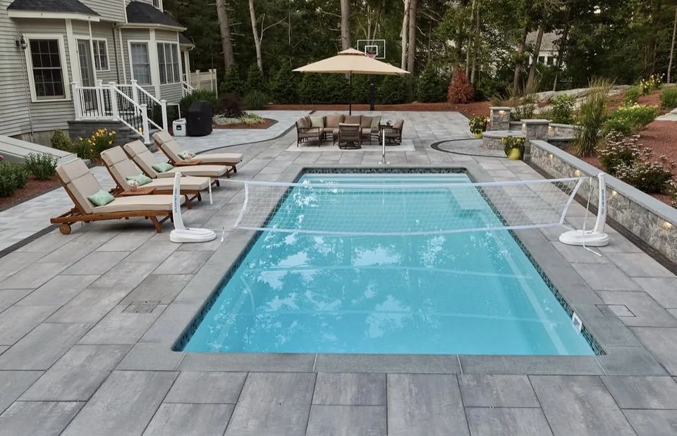 Pool deck with lounge chairs, seat wall and planted beds