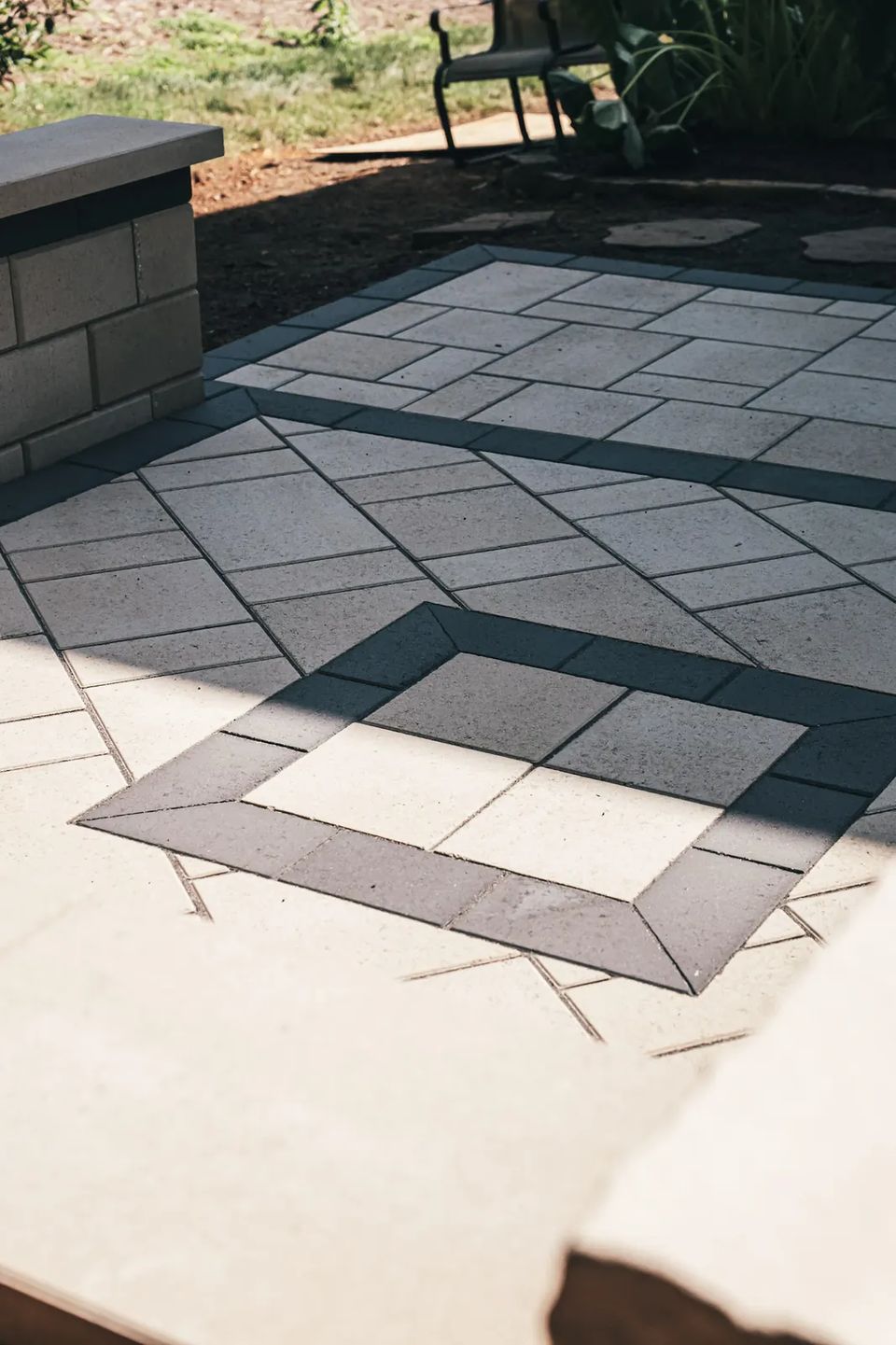 Square border inlay set into a large format slab patio