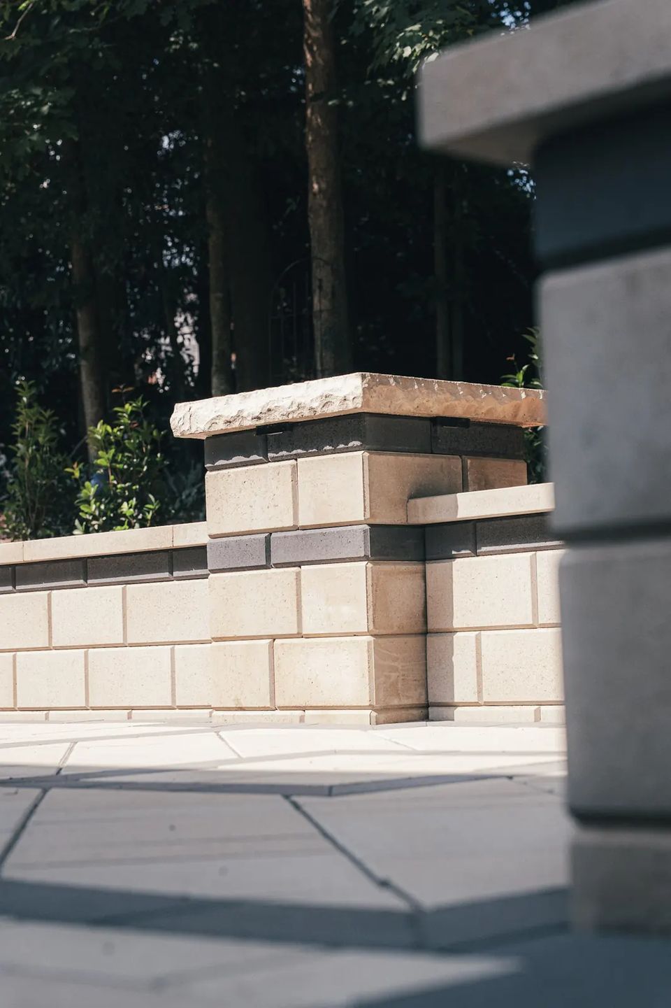 Seat wall pillar with a natural stone cap