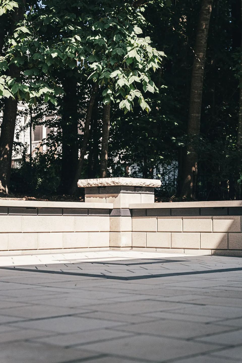 Seat wall pillar and caps in the shade of the trees