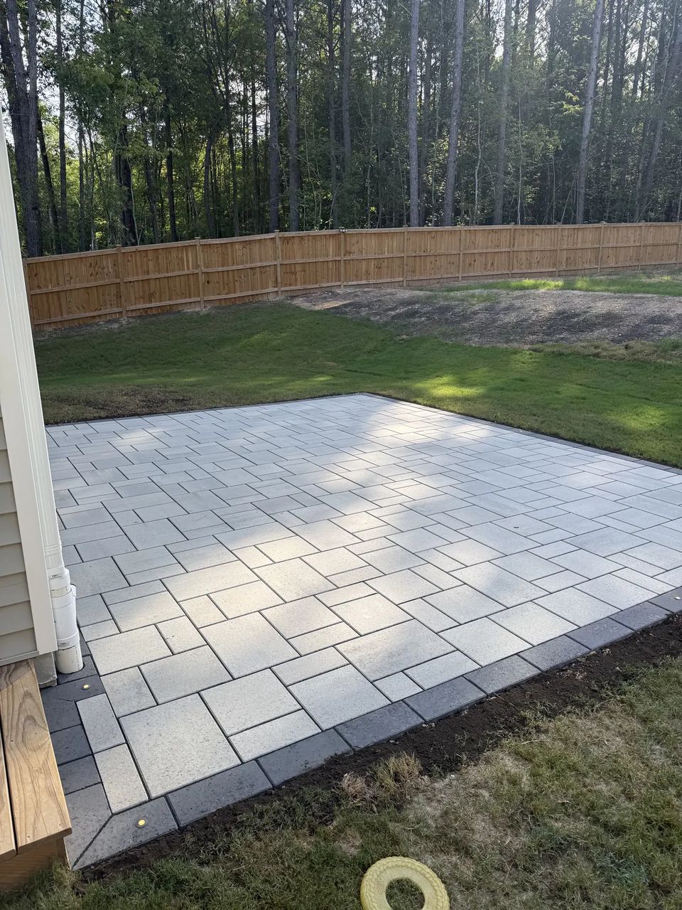 Slab patio running along the fence line