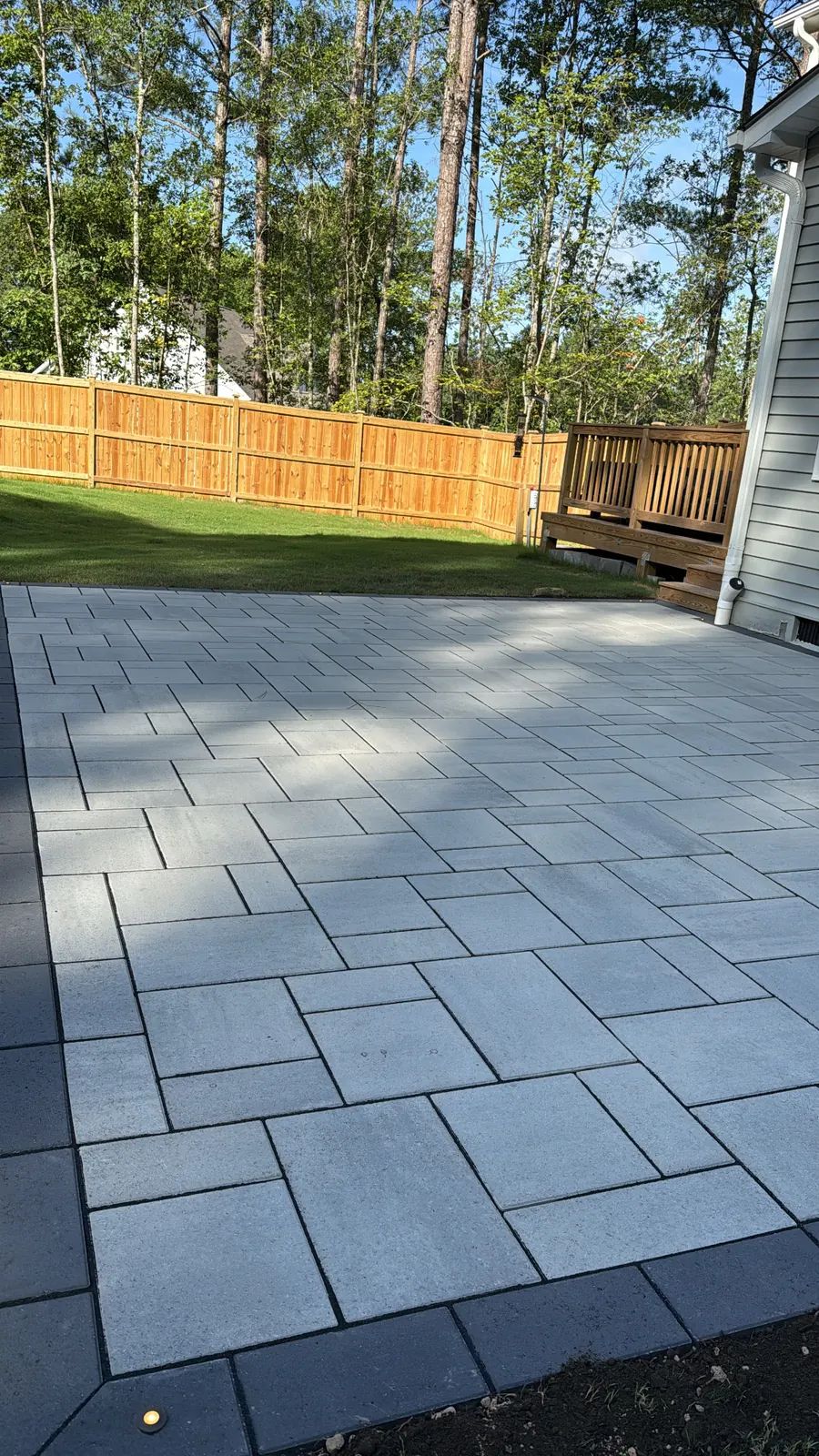 Long run of the slab patio toward the fence