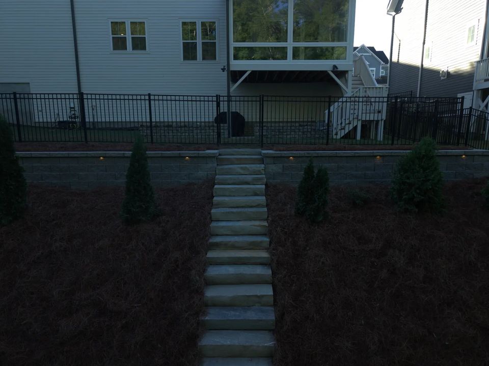 Stone stairs and lit wall on the slope at dusk