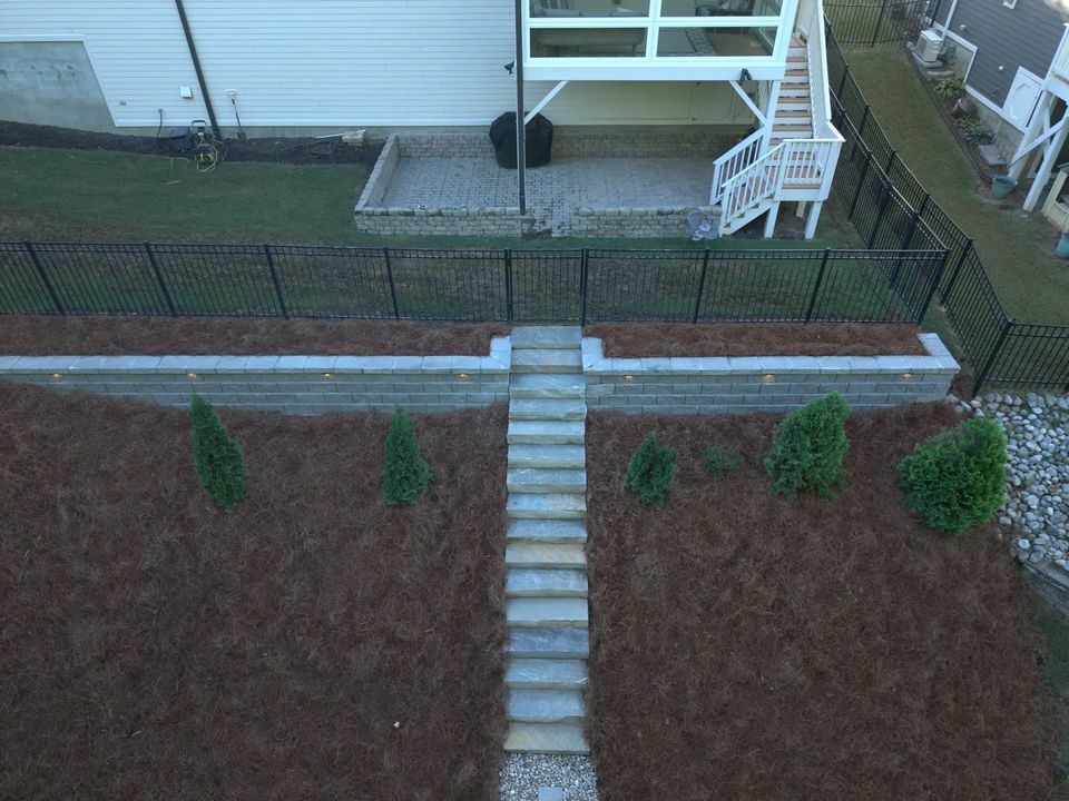 Drone view of stone stairs running up the slope to the wall