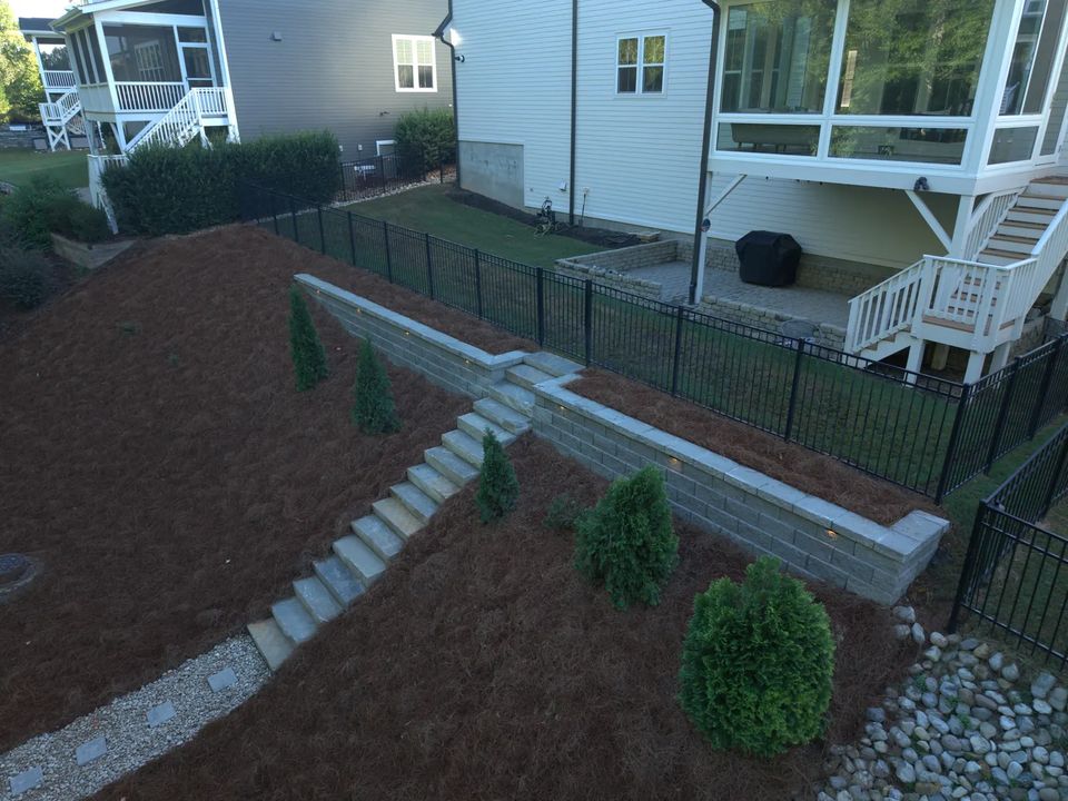 Wide view of the stairs, wall and planted slope