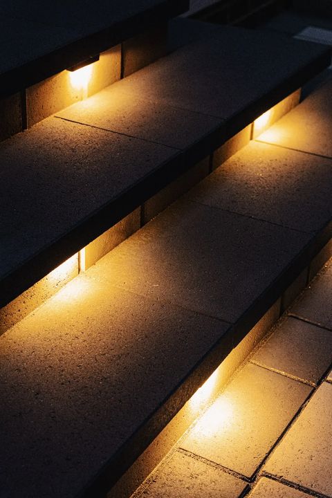 Row of step lights under dark paver treads