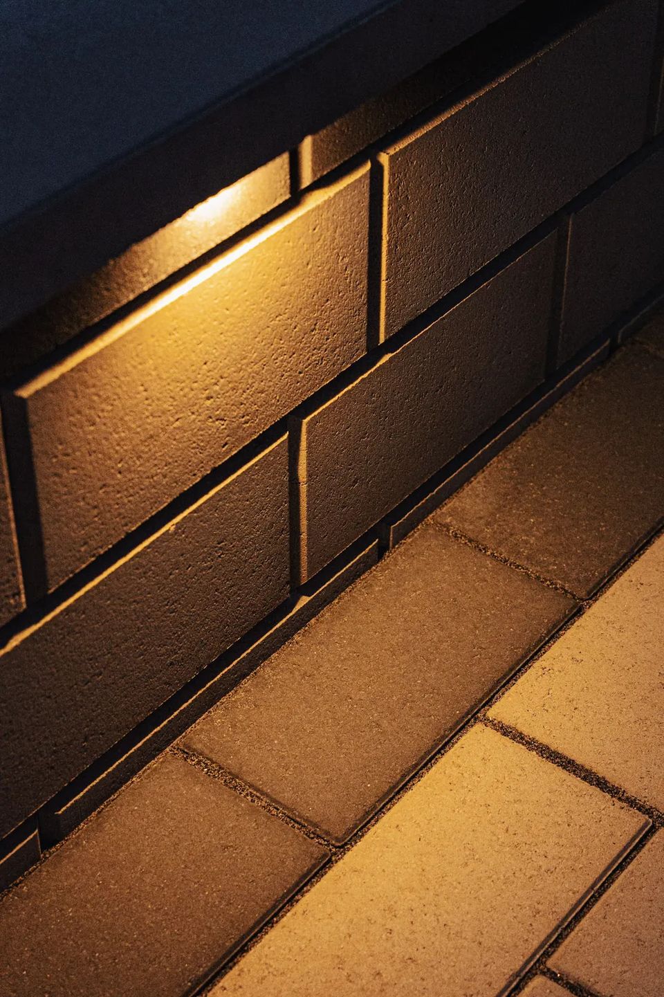 Wall light washing across block and pavers